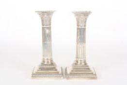 A pair of Victorian silver Corinthian column candlestickshallmarked Sheffield 1891, with Corinthian