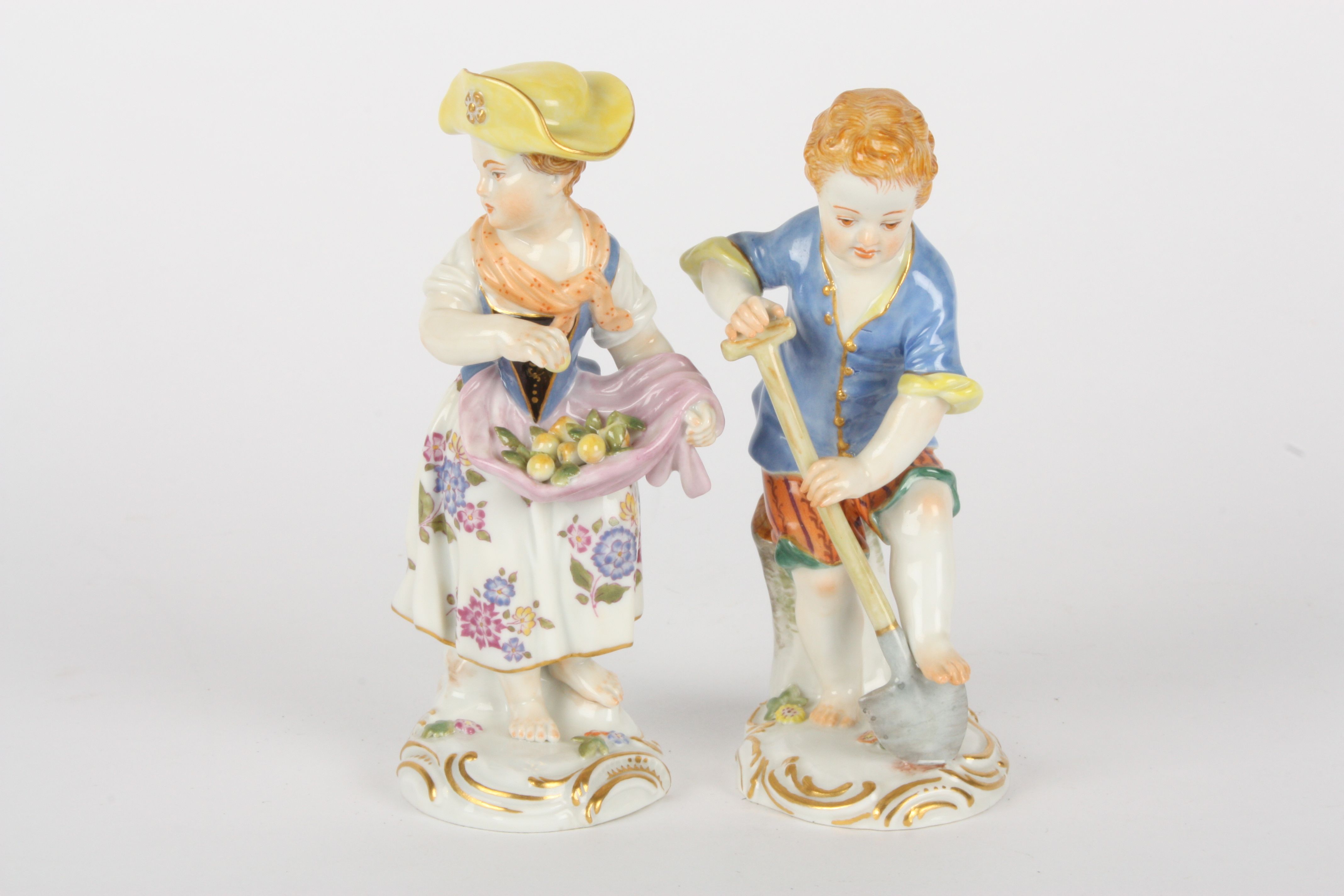 Pair of late 20th Meissen figures of gardening boy and girl, after Kaendler, the boy with spade