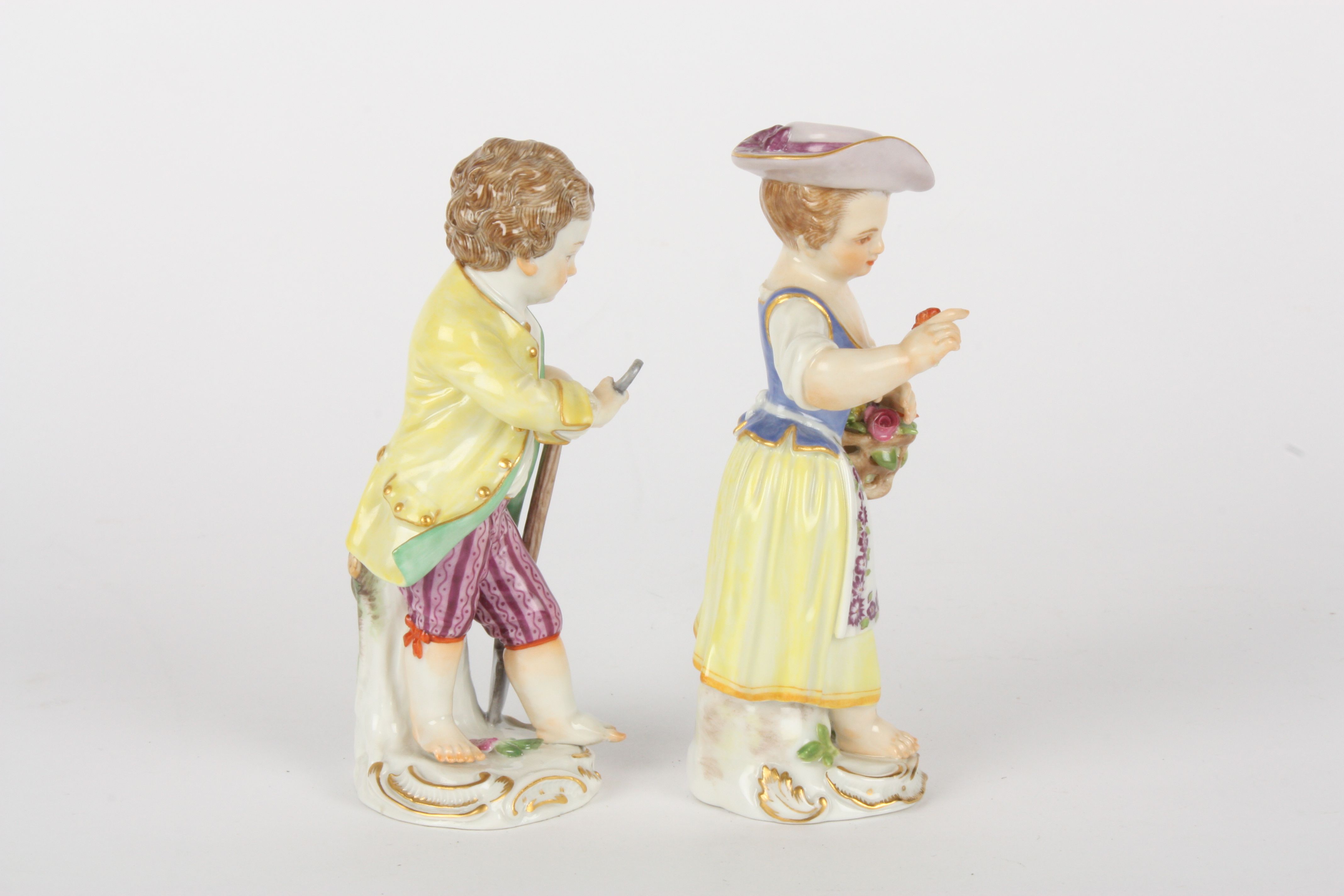 Pair of late 20th century Meissen gardener boy and girl figures, each modelled standing, boy holding - Image 4 of 5