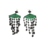 A pair of 1920s design French jet and jade earrings
formed as pierced and carved green jade fan