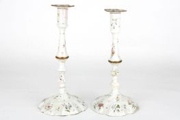 A large pair of 18th Century English enamelled metal candlesticksdecorated with vignettes and