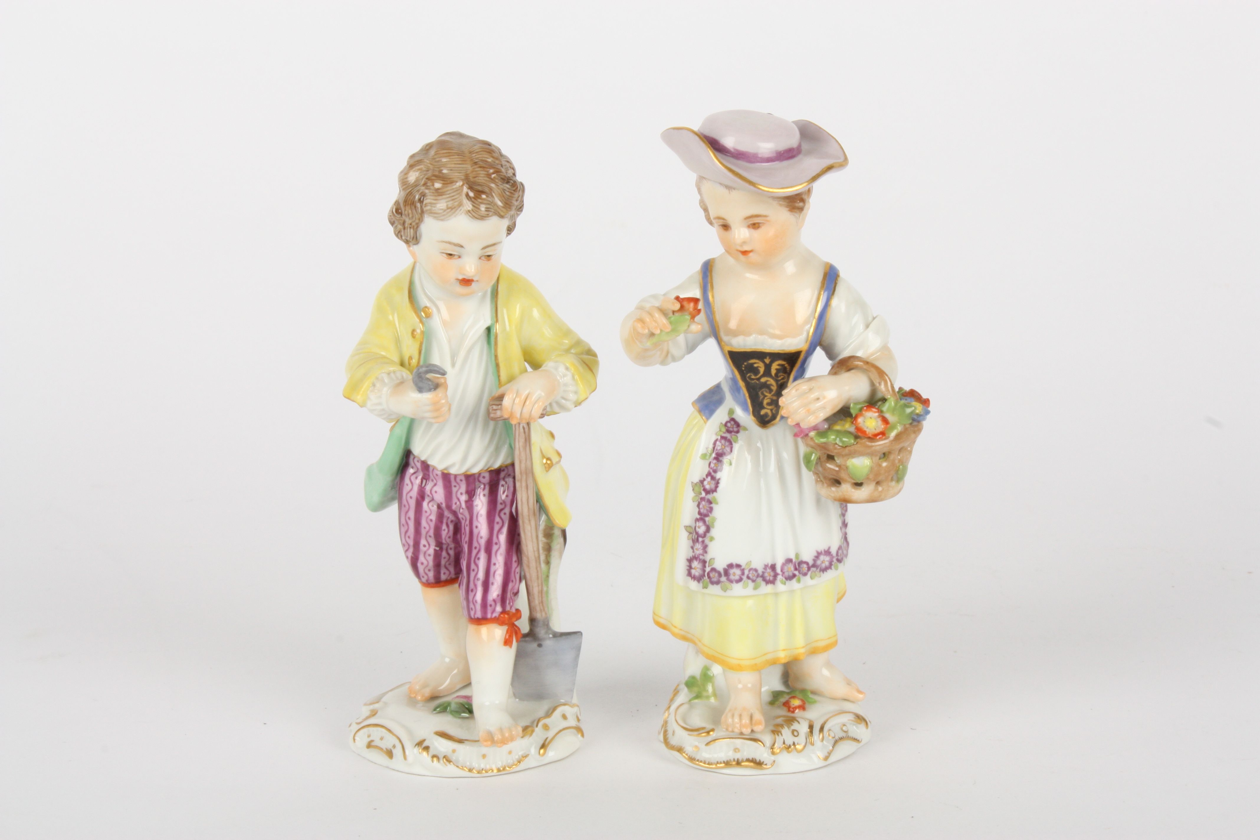 Pair of late 20th century Meissen gardener boy and girl figures, each modelled standing, boy holding