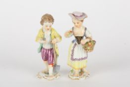 Pair of late 20th century Meissen gardener boy and girl figures, each modelled standing, boy holding