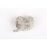 A diamond and white gold abstract scrolled brooch
set with two rows of diamonds, the largest