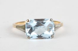 A 9ct gold and aquamarine ringthe stone of cushion shape and set in a plain gold mount, Size P.