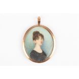 A 19th century portrait miniature of a young woman
in a simple black dress, her tied up, against a