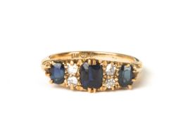 A George V 18ct gold, sapphire and diamond ringhallmarked Birmingham 1912, set with three sapphires