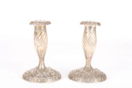 A pair of Victorian embossed silver candlestickshallmarked London 1890, makers mark Mappin &