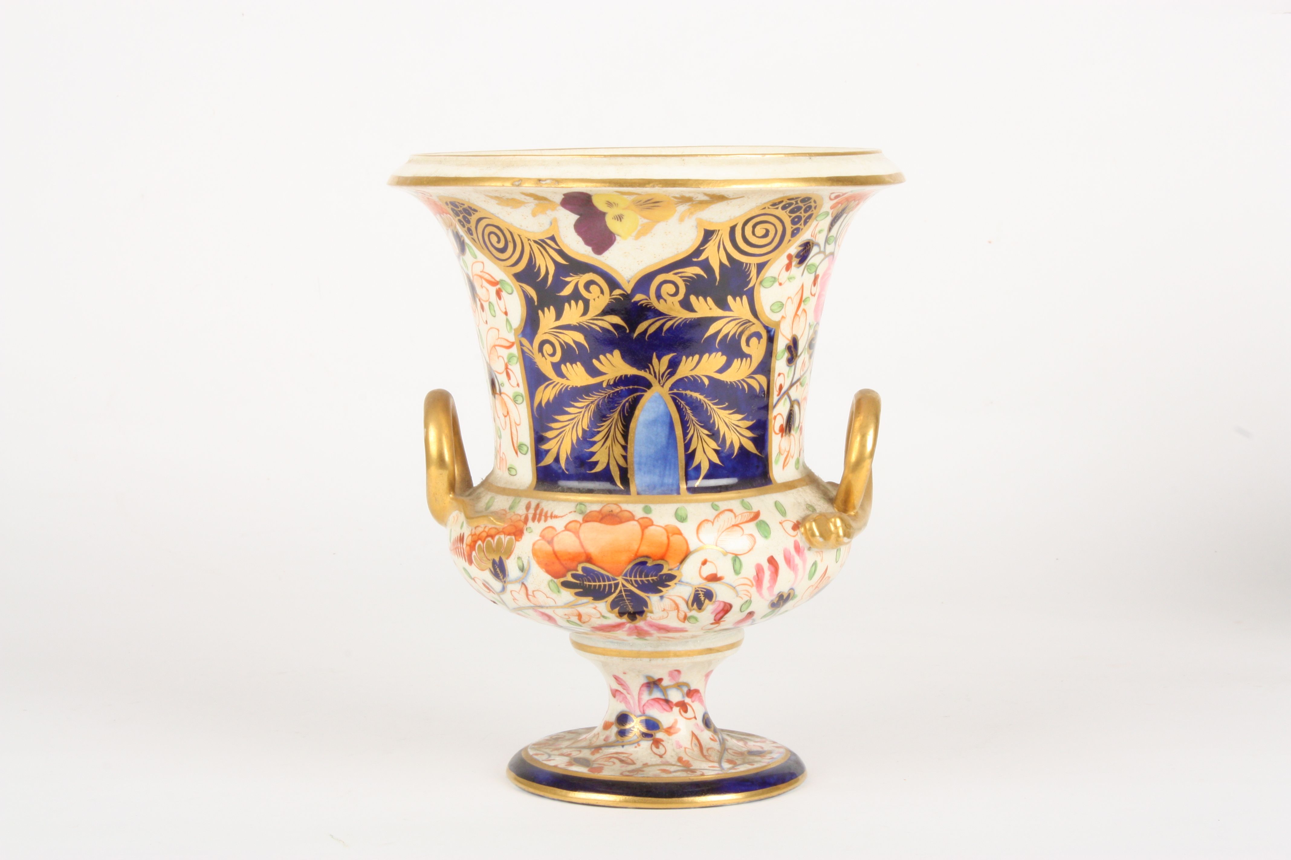 An early 19th century Derby Imari campagna urn
decorated with orange flowers, leaves and scrolls