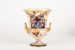 An early 19th century Derby Imari campagna urndecorated with orange flowers, leaves and scrolls