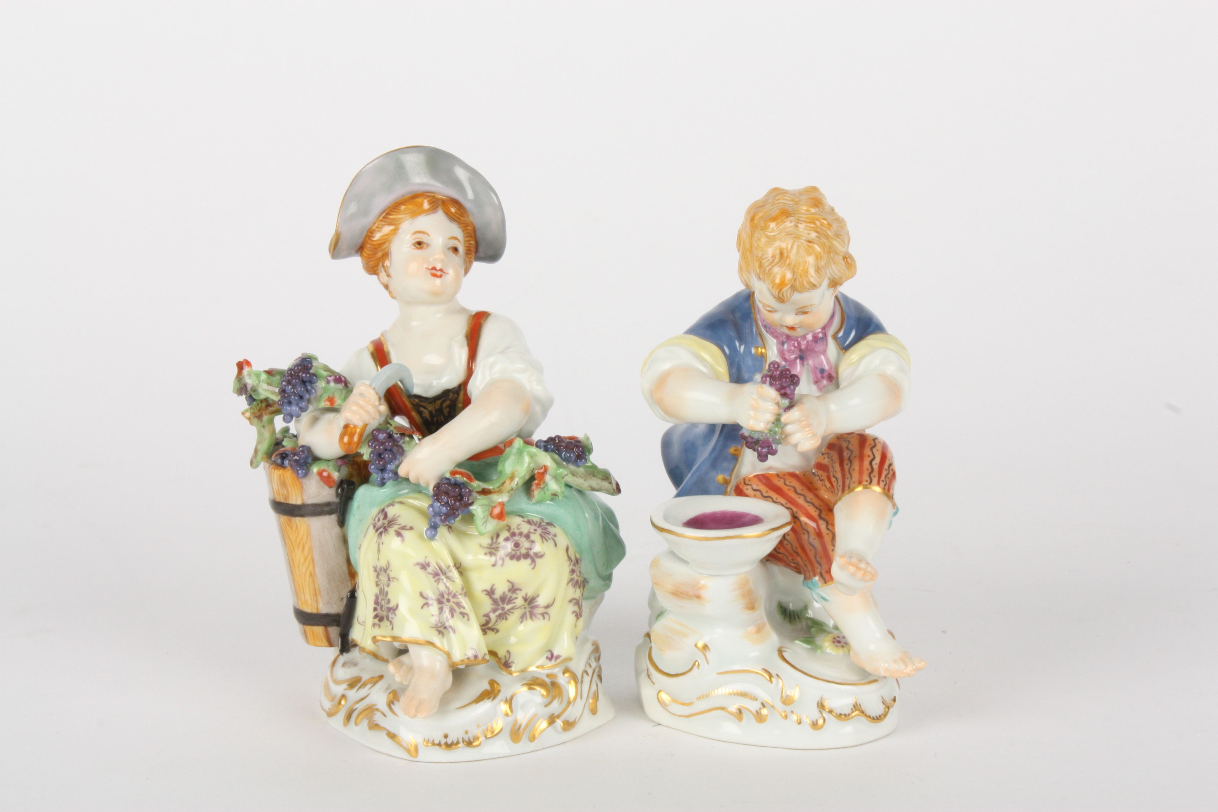 Pair of late 20th century Meissen gardener boy and girl, each modelled seated, girl with basket of