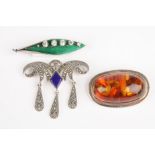 An early 20th century silver and enamel leaf brooch
together with a Baltic amber and silver brooch