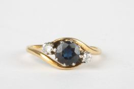 An 18ct gold, sapphire and diamond ringset with large central sapphire, flanked either side by