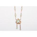 An Edwardian Art Nouveau 15ct gold, opal and diamond pendant necklace
formed as a central oval