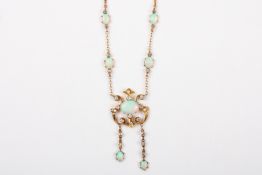 An Edwardian Art Nouveau 15ct gold, opal and diamond pendant necklaceformed as a central oval