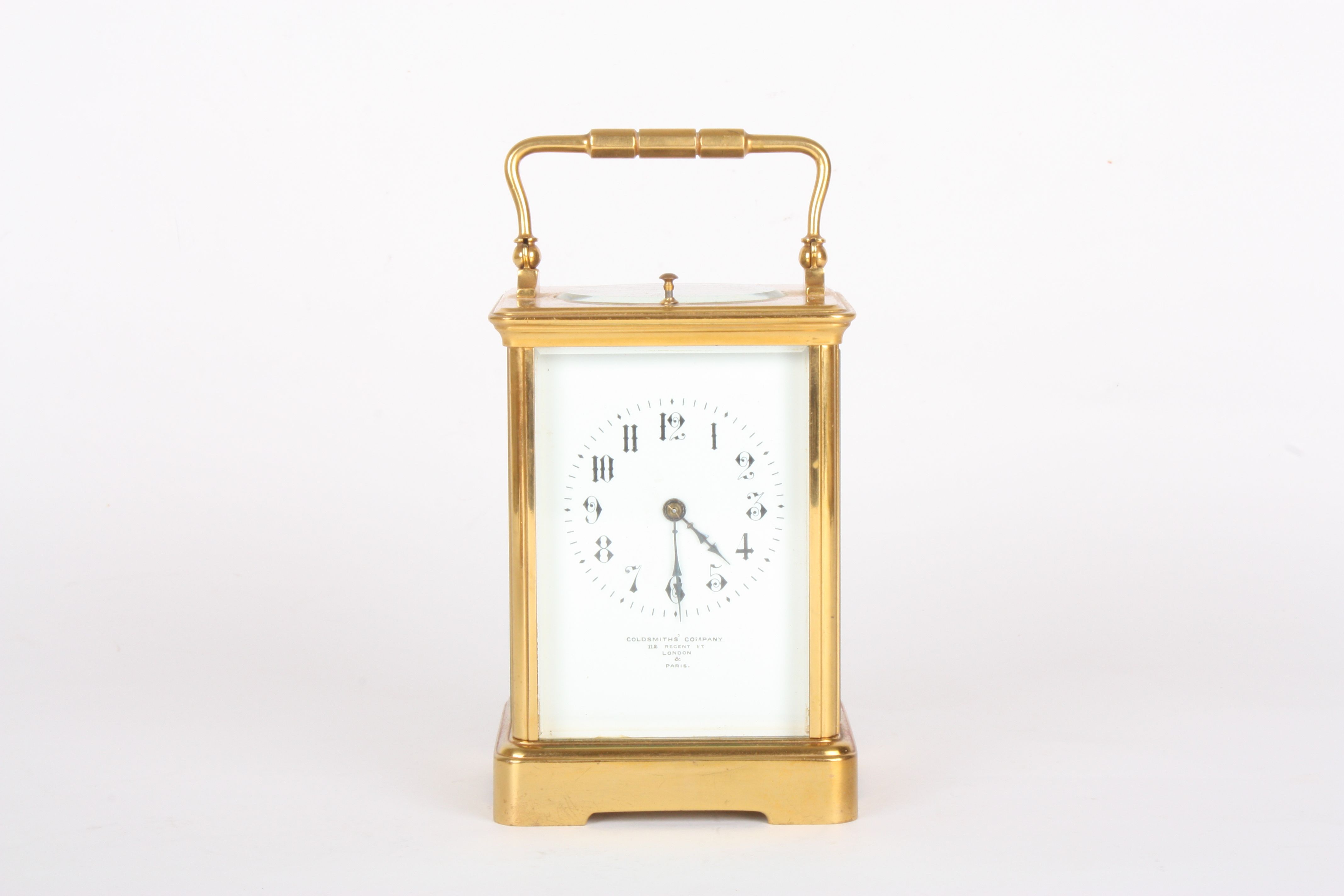 A Victorian brass carriage clock retailed by Goldsmiths Company
with repeating movement, the white