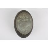 A Victorian carved Emu egg 'While the Billy Boils'
decorated with a cameo type scene of a man