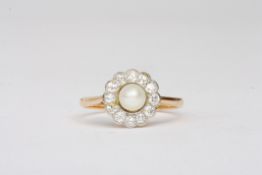 A diamond and pearl cluster ringset with central 4.5mm pearl surrounded by small diamonds in a