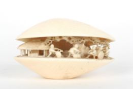 An early 20th century Chinese carved ivory clam shellcarved with a scene of figures working
