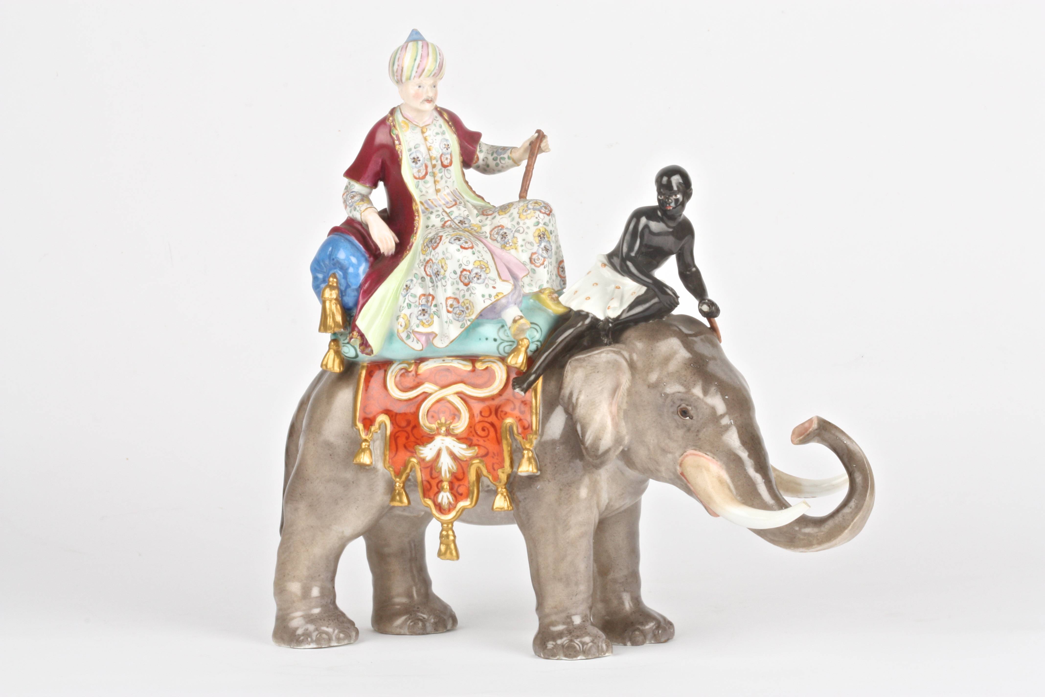 A late 19th century Meissen group of a sultan and black boy riding an elephant after a model by J.