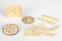 Two early 20th century Chinese carved ivory oval plaquesone mounted as a brooch, with finely