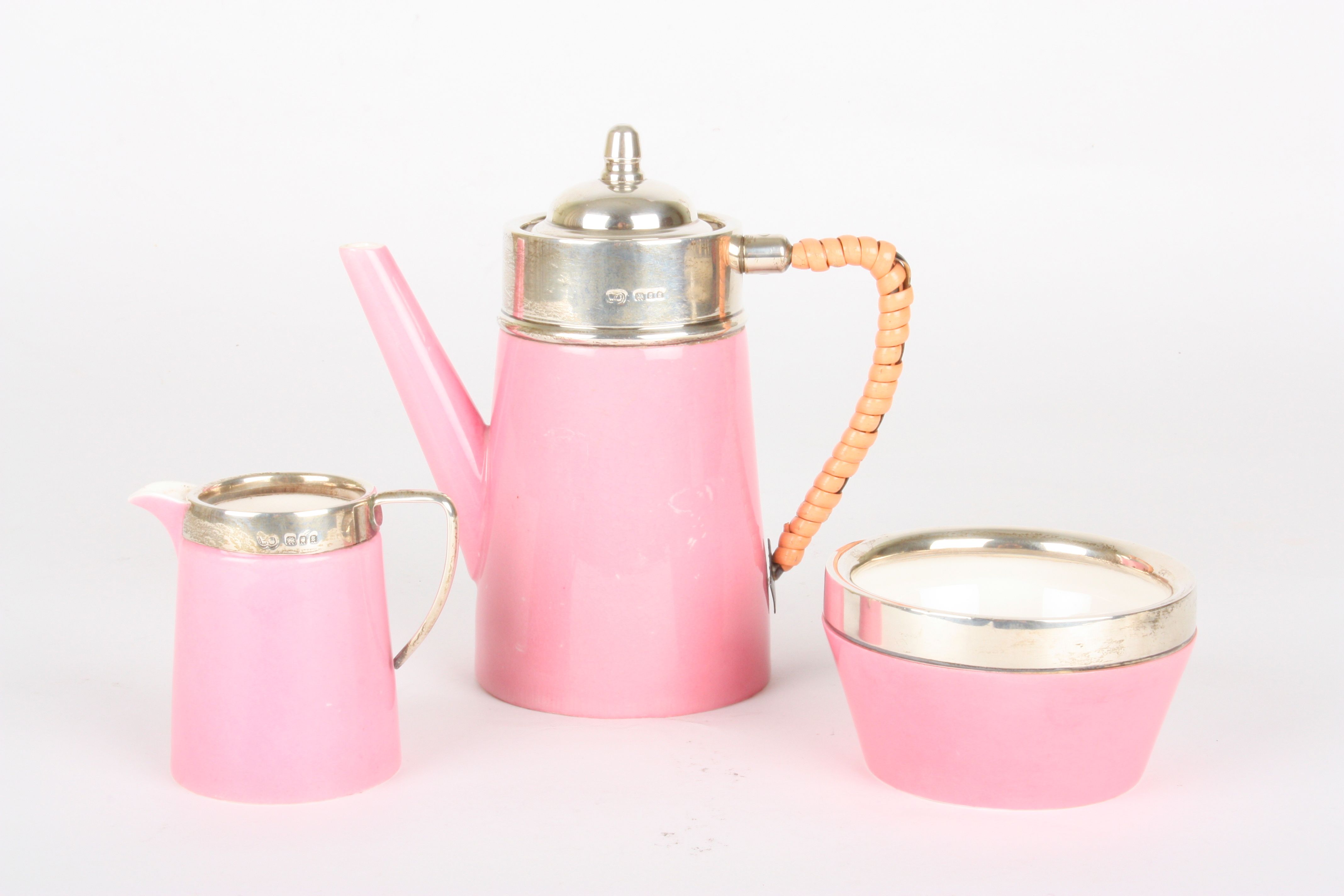 A Royal Worcester pink glazed and silver mounted 'tea for one' set
comprising teapot, milk jug and