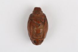 An early 20th century Chinese carved togglein the form of Buddha, 3 cm long.Condition: Good