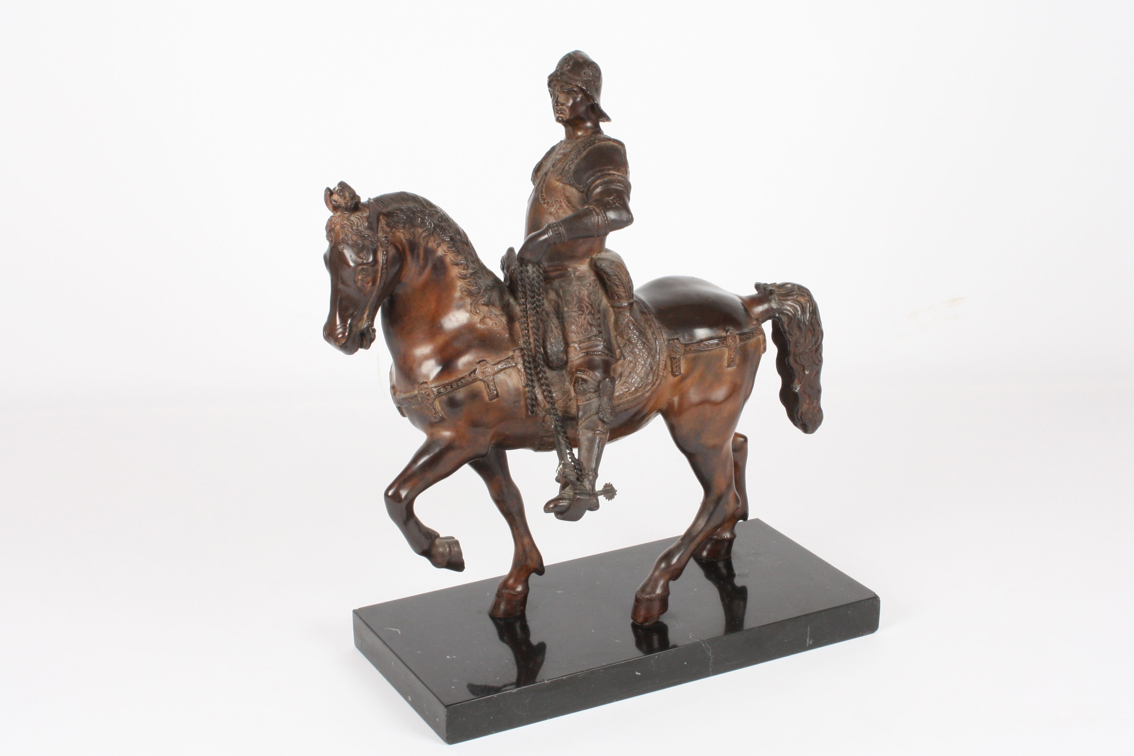 A 20th century bronze horse
the heavily cast sculpture depicting a warrior on a horse wearing