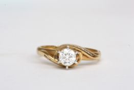 An 18ct gold and diamond solitaire ringthe diamond weighing approx 0.46cts, in a scrolled mount,