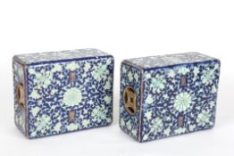 A pair of early 20th century Chinese porcelain pillow headrestsdecorated with turquoise flowers and