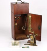 A late 19th century brass monocular microscopethe trunnions supported on a Y shaped base, with rack