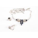 A silver and sapphire necklace and earring set
the necklace with central cluster of seven sapphires,