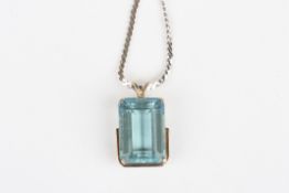 A large emerald cut aquamarine pendantstone measuring 19 x 14 x 9mm, set in a white metal mount,