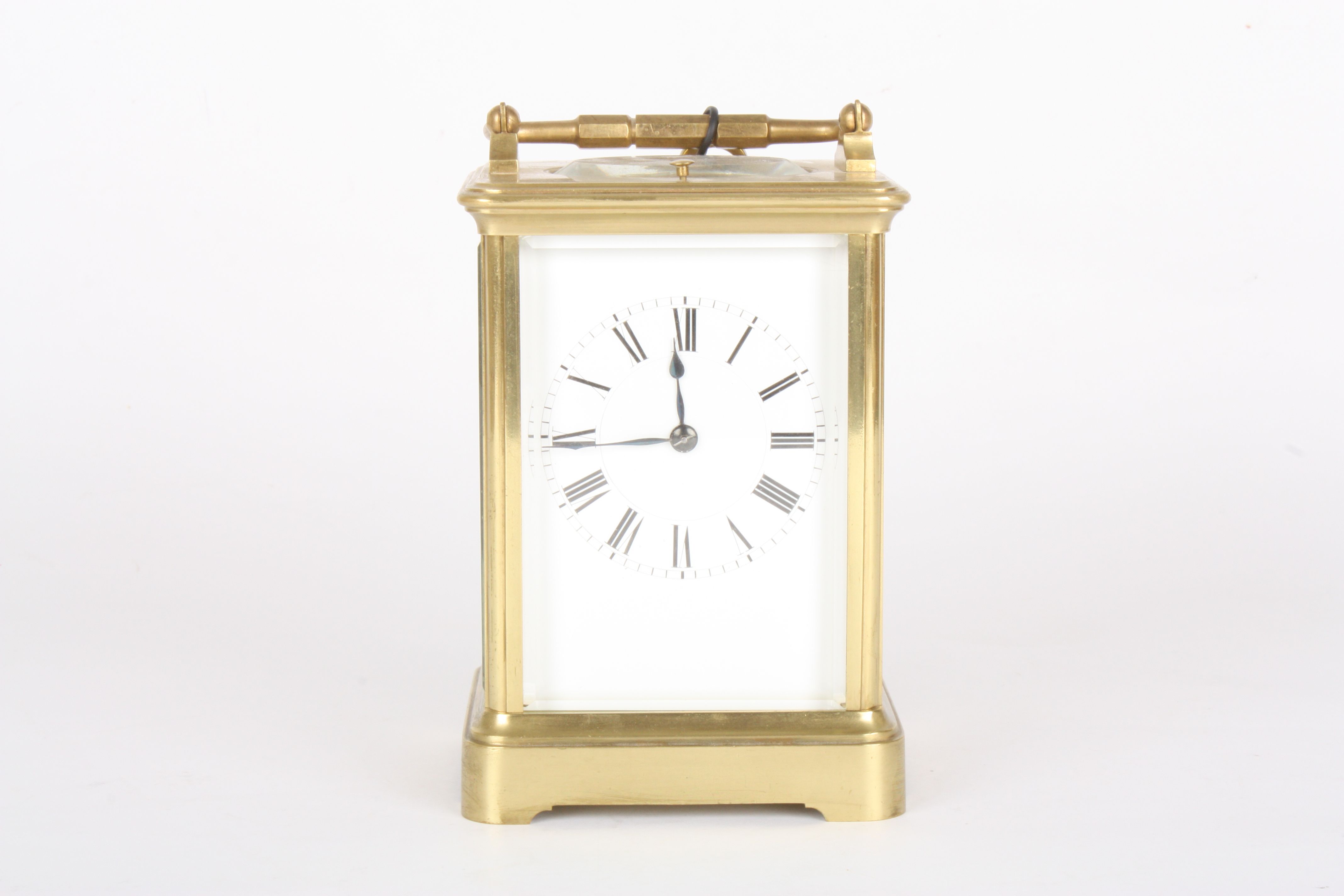 An early 20th century French brass repeating carriage clock
the white enamel dial with black Roman