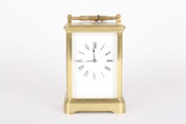 An early 20th century French brass repeating carriage clockthe white enamel dial with black Roman