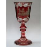 19th CENTURY STYLE RED OVERLAID STEMMED GOBLET WITH ENGRAVING DEPICTING GERMAN SCENES,