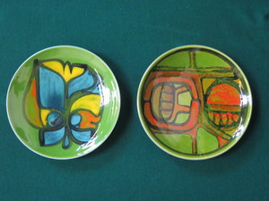 TWO POOLE GLAZED CERAMIC CIRCULAR PLAQUES,