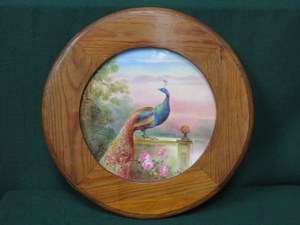 FRAMED HANDPAINTED CIRCULAR PORCELAIN PANEL DEPICTING A PEACOCK, SIGNED W BIRBECK,