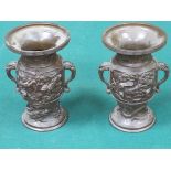 PAIR OF BRONZE STYLE RELIEF DECORATED VASES IN THE ORIENTAL MANNER,