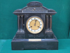 LARGE BLACK SLATE MANTLE CLOCK WITH ENAMELLED AND CIRCULAR DIAL,