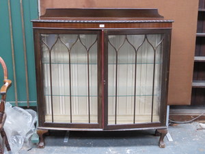 MAHOGANY BOW FRONTED TWO DOOR GLAZED DISPLAY CABINET ON BALL AND CLAW SUPPORTS