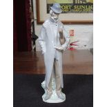 LLADRO GLAZED CERAMIC FIGURE OF A GENT WITH CASED MUSICAL INSTRUMENT