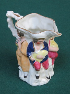 EARLY 19th CENTURY STAFFORDSHIRE HANDPAINTED FIGURE FORM CERAMIC MILK JUG,