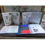 FOUR STAMP ALBUMS CONTAINING BRITISH AND FOREIGN POSTAGE STAMPS