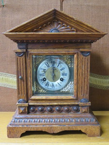 CARVED OAK CASED BRACKET CLOCK WITH BRASS DIAL