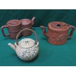 TWO UNGLAZED ORIENTAL TEAPOTS, ONE WITH RELIEF DECORATION,