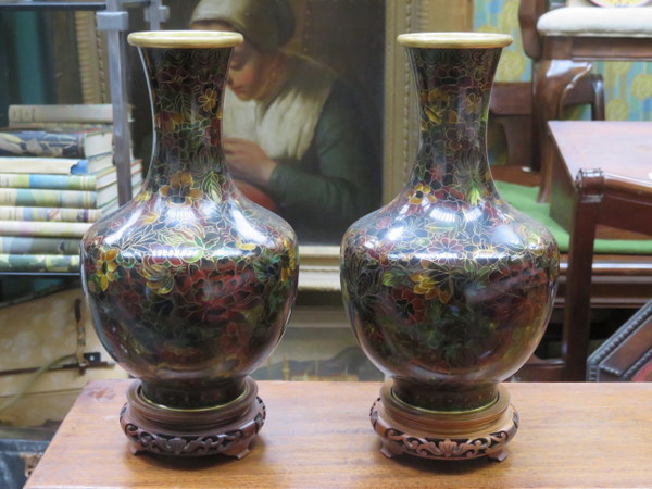 PAIR OF FLORAL DECORATED CLOISONNE VASES ON CARVED PIERCEWORK TREEN STANDS,