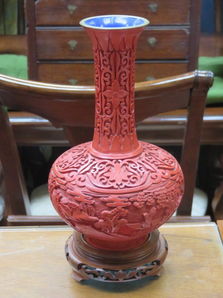 HEAVILY CARVED ORIENTAL CINNABAR STYLE VASE WITH CLOISONNE INTERIOR AND BASE ON CARVED PIERCEWORK