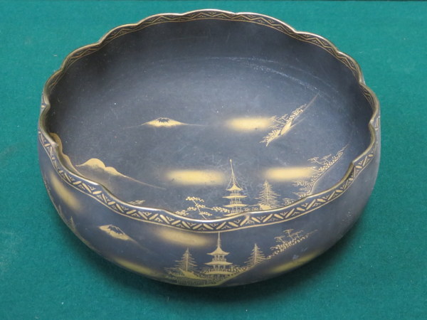 JAPANESE UNGLAZED BLACK SATSUMA WAVE EDGED BOWL WITH GILDED MOUNTAIN SCENE DECORATION,