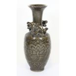 An interesting Chinese olive green glazed incised pottery vase H18cms